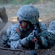 A cadet waits for a signal from her partner during a hand grenade training course.