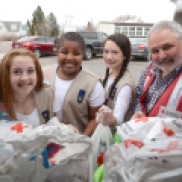 Local girl scouts help pack kits for families who have lost their homes to fires.