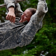 A cadet, known as Mama G, struggles trough the last few feet of a descending rope climb at an obstacle course at LDAC